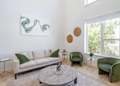 Thumbnail 24 of 78 - a living room with a couch and chairs and a coffee table