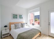 Thumbnail 53 of 78 - a bedroom with a bed and a window