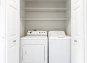 Thumbnail 16 of 39 - Pet-Friendly Apartments in Houston, TX – Westchase Forest – Photo of a small laundry room with a washer and dryer