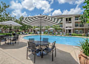 Thumbnail 19 of 39 - Pet-Friendly Apartments in Houston, TX – Westchase Forest – Photo of our apartments offer a swimming pool with tables and umbrellas