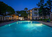 Thumbnail 21 of 39 - Pet-Friendly Apartments in Houston, TX – Westchase Forest – Photo of the swimming pool at night at the preserve at polk apartments