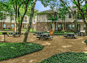 Thumbnail 34 of 39 - Pet-Friendly Apartments in Houston, TX – Westchase Forest – Photo of our apartments have a spacious courtyard with picnic tables