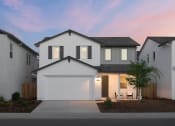 Thumbnail 30 of 31 - a white house with a garage door in front of it