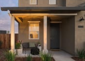 Thumbnail 8 of 31 - a patio with a table and chairs in front of a house