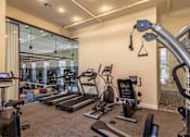 Thumbnail 29 of 39 - Affordable Apartments Near San Antonio River N Park San Antonio, TX - The St. John - A Gym With Matrix Cardio Equipment, A Functional Training Rack, And Resistance Bands, And Concrete Ceilings.