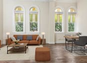 Thumbnail 2 of 39 - A living room with a brown sofa and a coffee table.