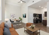 Thumbnail 3 of 39 - A living room with a brown couch and a coffee table.