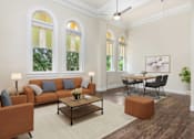 Thumbnail 4 of 39 - San Antonio, TX, Affordable Apartments With In-Unit Washer And Dryer - The St. John - A Spacious Living Room With Historic Arched Windows, A Tan Sofa, And A Modern Dining Area.