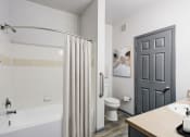 Thumbnail 10 of 18 - Parc at Metro Center Apartments near Buena Vista Heights, TN photo of a bathroom with a shower and a toilet and a sink