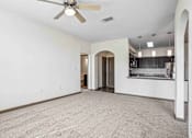 Thumbnail 16 of 33 - 1 & 2-Bedroom Apartments for Rent in Bentonville, AR – Parc at Bentonville – Living Room with ceiling fan and plush carpeting