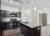 Thumbnail 13 of 33 - 1 & 2-Bedroom Apartments for Rent in Bentonville, AR – Parc at Bentonville – Kitchen with granite countertops