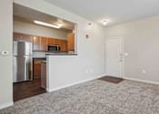 Thumbnail 10 of 25 - 1, 2 & 3-Bedroom Apartments for Rent in Maumelle, AR – Parc at Maumelle – A kitchen with a refrigerator, microwave, and a countertop.