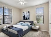 Thumbnail 7 of 25 - 1, 2 & 3-Bedroom Apartments for Rent in Maumelle, AR – Parc at Maumelle – A bedroom with a large bed and a ceiling fan.
