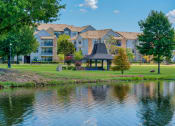 Thumbnail 22 of 25 - 1, 2 & 3-Bedroom Apartments for Rent in Maumelle, AR – Parc at Maumelle –Exterior photo with a pond and covering