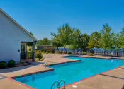 Thumbnail 15 of 25 - a swimming pool surrounded by trees and beach chairs