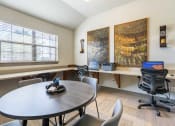 Thumbnail 19 of 25 - 1, 2 & 3-Bedroom Apartments for Rent in Maumelle, AR – Parc at Maumelle – A office room with table and chairs and desks with cahirs