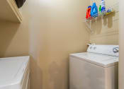 Thumbnail 13 of 25 - 1, 2 & 3-Bedroom Apartments for Rent in Maumelle, AR – Parc at Maumelle – a small laundry room with a washer and dryer