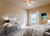 Thumbnail 10 of 25 - Apartments in Clarksville, TN for Rent - Parc at Clarksville - bedroom with ceiling fan and large window with curtains