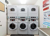 Thumbnail 14 of 15 - Hayward, CA Apartments - Paseo Gardens - Onsite Laundry Room with Stacked White Machines