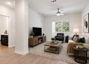 Thumbnail 2 of 14 - A living room with a television, couch, and a rug.