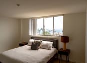 Thumbnail 10 of 29 - a bedroom with a bed and a large window