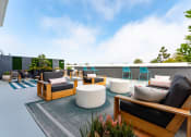 Thumbnail 11 of 29 - Santa Monica, CA Apartments- San Vicente Tower - Rooftop Resident Lounge with Lounge Seating, Area Rugs, and Views of the Ocean