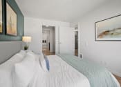 Thumbnail 10 of 43 - a bedroom with a large white bed and a gray couch