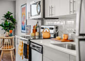 Thumbnail 11 of 43 - a kitchen with white cabinets and a sink