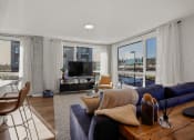 Thumbnail 2 of 43 - a living room with a navy blue couch and a tv