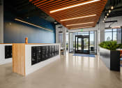 Thumbnail 32 of 43 - a reception area with a wooden desk and a glass door