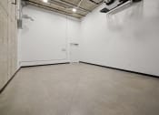 Thumbnail 34 of 43 - an empty room with a white wall and a cement floor