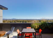 Thumbnail 36 of 43 - a patio with a table and chairs and a view of the mountains