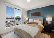 Thumbnail 4 of 43 - a bedroom with a bed and a large window