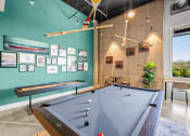 Thumbnail 39 of 43 - a pool table in a game room with a view
