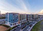 Thumbnail 43 of 43 - an aerial view of an apartment building next to a parking lot
