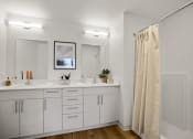 Thumbnail 5 of 43 - a bathroom with two sinks and a shower and a mirror