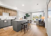 Thumbnail 9 of 43 - a kitchen with a island and stools in a living room
