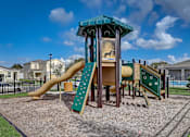 Thumbnail 10 of 36 - A playground with a slide and a wooden structure.