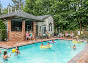 Thumbnail 22 of 35 - Apartments In Everett, WA, For Rent - Woodbrook - Gated Outdoor Pool Surrounded By Lush Greenery.