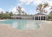 Thumbnail 10 of 28 - Omnia at Richmond Hill Townhomes in Georgia photo of a large pool with a building in the background