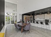 Thumbnail 22 of 38 - a dining room with a table and chairs and a kitchen