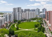 Thumbnail 37 of 38 - an aerial view of a park in a city with tall buildings