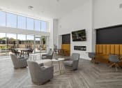 Thumbnail 9 of 38 - a living room with chairs and a table and a television