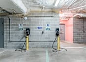 Thumbnail 24 of 25 - Two electric vehicle charging stations are located in a parking garage.
