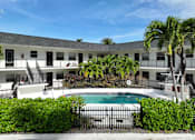 Thumbnail 6 of 8 - Swimming pool at RTW Rentals in Fort Lauderdale featuring tropical landscaping, outdoor seating areas, and relaxing community gathering spaces.
