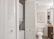 Thumbnail 8 of 31 - A white toilet sits in a bathroom next to a white cabinet.