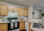 Thumbnail 18 of 26 - kitchen with double sink and oven and microwave and refrigerator