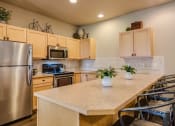 Thumbnail 6 of 26 - Coeur d'Alene, ID, Apartments For Rent - Rockwood Lodge - Spacious Kitchens With Abundant Cabinets, Wood-Style Flooring, Stainless Steel Appliances, And Breakfast Bar With Seating.