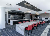 Thumbnail 22 of 31 - 3thirty3 new rochelle ny apartment high rise photo of co-working area with large community table work station made of marble with modern furniture and finishes next to community kitchen area