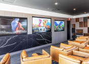 Thumbnail 21 of 31 - 3thirty3 new rochelle ny apartment high rise photo of media room with leather club chairs and multiple televisions TVs and modern accents